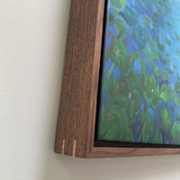 Framed artwork with a wooden frame on a white wall