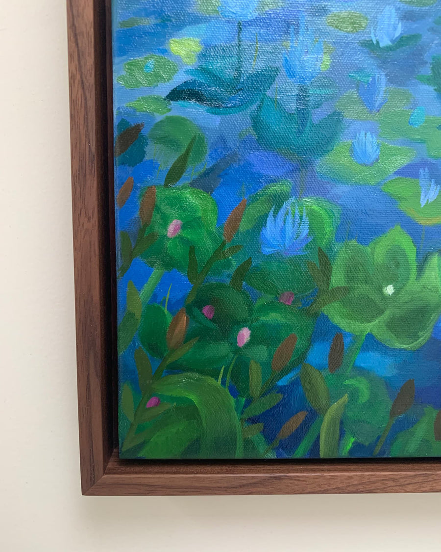 Framed painting of a underwater scene with green plants and blue water.