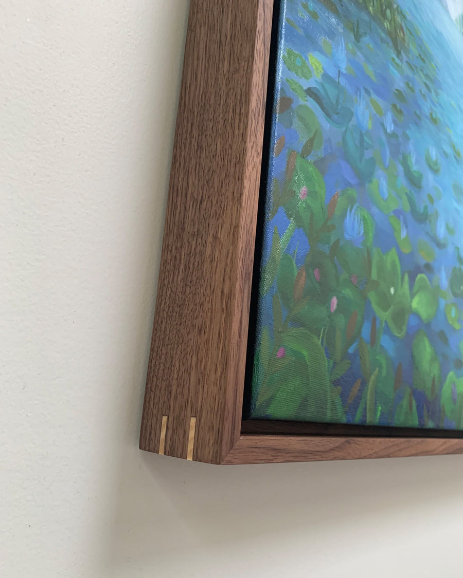 Framed artwork with a wooden frame on a white wall