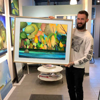 Vancouver Artist Sam Siegel holding his painting