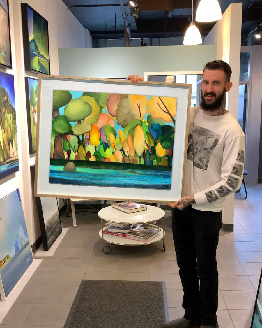 Vancouver Artist Sam Siegel holding his painting